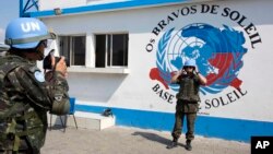 A U.N. peacekeeper from Brazil poses for a souvenir photo before the start of a patrol in the Cite Soleil slum, in Port-au-Prince, Haiti, Feb. 22, 2017.