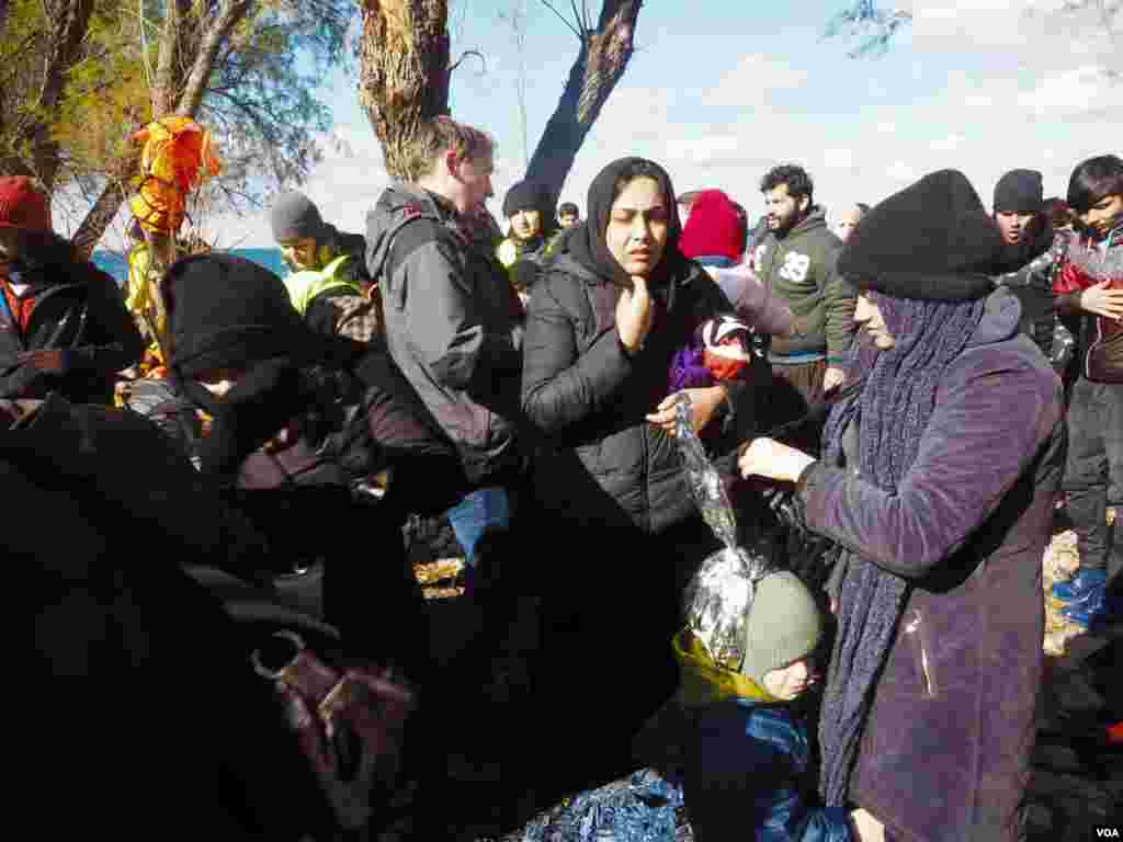 Aid workers say when the people arrive on shore, their clothes are usually wet, and in cold weather, the wet clothes can quickly freeze, Lesbos, Greece, Jan. 19, 2016. (VOA/Hamada Elrasam) 