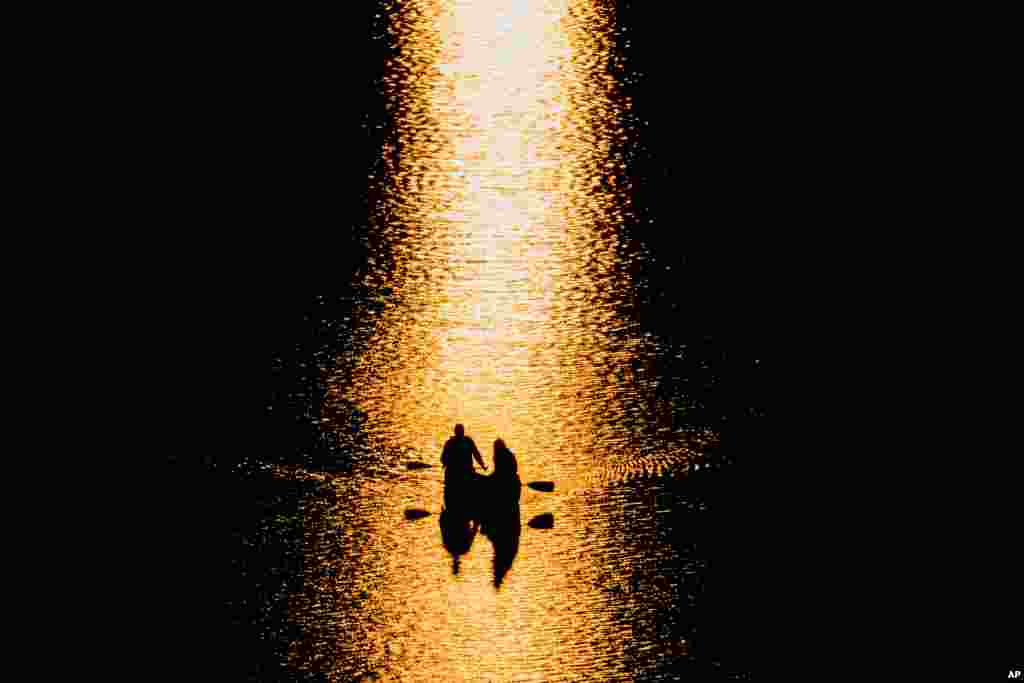 Canoists on the Potomac River pause to watch the sunset in Washington, D.C., April 3, 2016