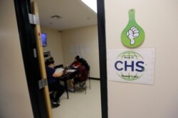 Migrant teens a work in their dorm room at a Comprehensive Health Services "tender-age" facility, a facility for babies, children and teens, in Texas' Rio Grande Valley, Aug. 29, 2019, in San Benito, Texas.
