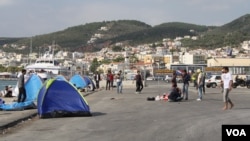 At the port in Lesvos, Greece, many refugees from Afghanistan, Iraq and Syria who cannot afford the 48 euros for a boat to their next destination wait in tents, many hoping to find another way, Sept. 12, 2015. (Credit: Heather Murdock/VOA)