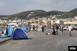 At the port in Lesvos, Greece, many refugees from Afghanistan, Iraq and Syria who cannot afford the 48 euros for a boat to their next destination wait in tents, many hoping to find another way. (Credit: Heather Murdock/VOA)