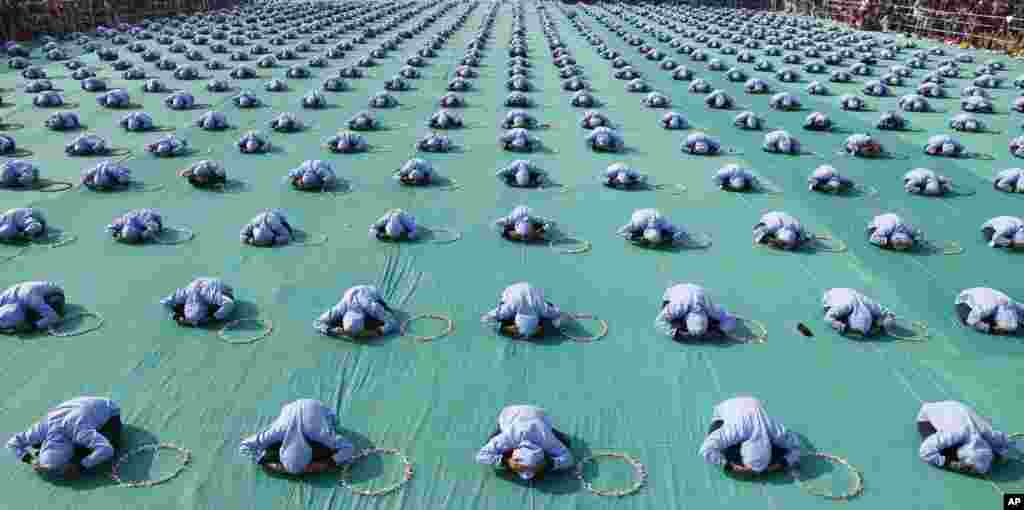 Indian school children perform yoga during the inauguration of International kite festival in Ahmadabad.