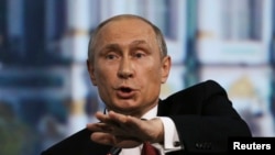 Russia's President Vladimir Putin speaks during a session of the St. Petersburg International Economic Forum 2014 in St. Petersburg, Russia, May 23, 2014.
