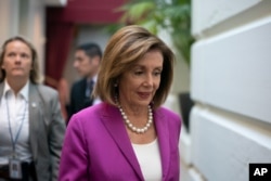 FILE - House Speaker Nancy Pelosi, D-Calif., arrives for a closed-door session with her caucus at the Capitol in Washington, July 16, 2019.