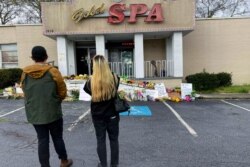 People view a makeshift memorial, March 19, 2021, in Atlanta. Robert Aaron Long, a white man, is accused of killing several people, most of whom were of Asian descent, at massage parlors in the Atlanta area.