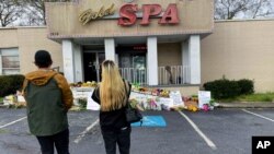 People view a makeshift memorial, March 19, 2021, in Atlanta. Robert Aaron Long, a white man, is accused of killing several people, most of whom were of Asian descent, at massage parlors in the Atlanta area.