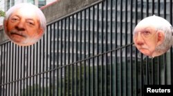 FILE - Inflatable dolls depicting Brazil's former President Luiz Inacio Lula da Silva (L) and Eduardo Cunha are displayed during a protest calling for the impeachment of Brazil's President Dilma Rousseff.