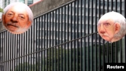 Inflatable dolls of Brazil's former President Luiz Inacio Lula da Silva (L) and President of the Chamber of Deputies Eduardo Cunha are shown during a protest in Sao Paulo, Dec. 13, 2015. 