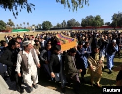 Afghan men carry the coffin of journalist Malalai Maiwand, who was shot and killed by unknown gunmen in Jalalabad, Afghanistan, Dec. 10, 2020.