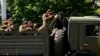 FILE - A military truck with armed pro-Russian rebels is seen driving through a police check-point towards the airport of the eastern Ukrainian city of Donetsk May 26, 2014.