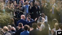Staff members applaud as outgoing national security adviser H.R. McMaster walks out of the West Wing of the White House in Washington, April 6, 2018, on his last day.