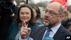 FILE - Chairman of Germany's Social Democratic Party Martin Schulz, right, and the SPD faction leader in the Bundestag, Andrea Nahles, speak to reporters in Berlin.