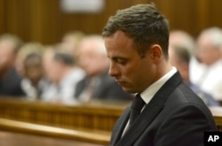 FILE - Oscar Pistorius sits in court, after being sentenced to five years in prison, Oct. 21, 2014.