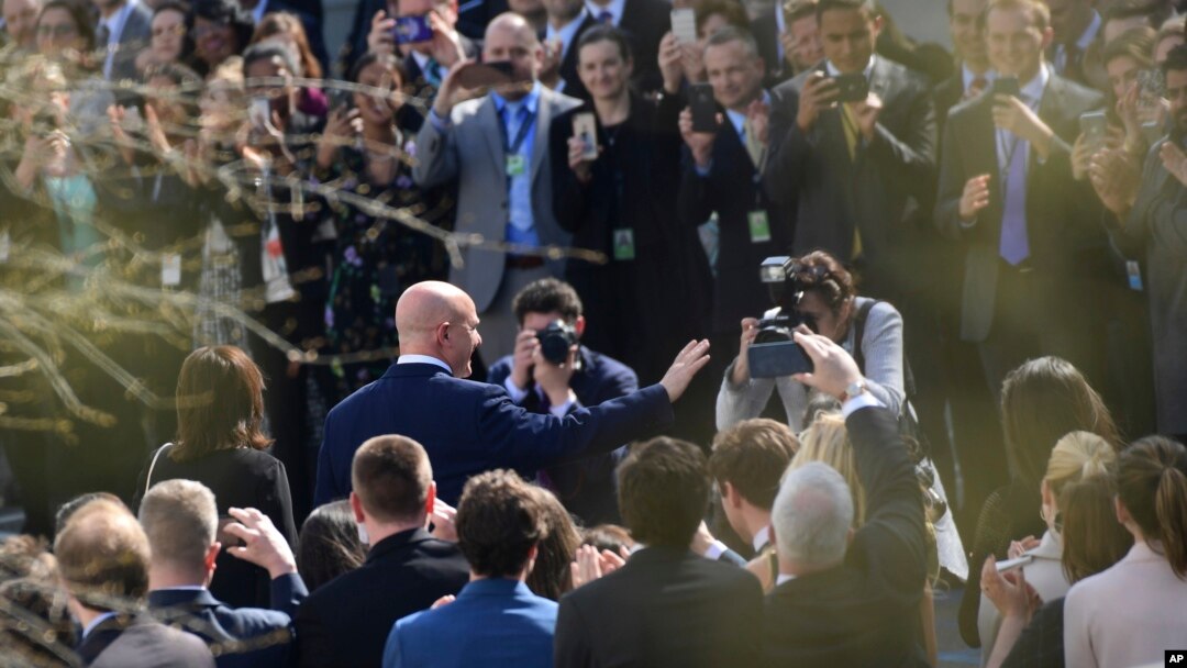 Staff members applaud as outgoing national security adviser H.R. McMaster walks out of the West Wing of the White House in Washington, April 6, 2018, on his last day.