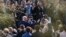 Staff members applaud as outgoing national security adviser H.R. McMaster walks out of the West Wing of the White House in Washington, April 6, 2018, on his last day.