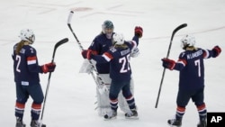 USA Goalkeeper Jessie Vetter and Amanda Kessel meet near mid ice with Lee Stecklein and Monique Lamoureux after defeating Sweden 6-1 during a 2014 Winter Olympics women's semifinal ice hockey game at Shayba Arena, Monday, Feb. 17, 2014.