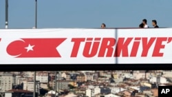 Pedestrians cross a bridge over a highway in Istanbul, Aug. 18, 2016. 