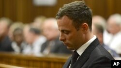 FILE - Oscar Pistorius sits in court, after judge Thokozile Masipais sentenced him to five years in prison, in Pretoria, South Africa, Oct. 21, 2014.