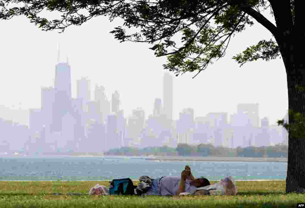 June 8: A woman rests during hot weather at Montrose beach in Chicago. (AP Photo/Nam Y. Huh)
