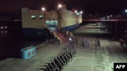 This screen grab taken from video released on August 29, 2019 from China's state-run CCTV shows People's Liberation Army (PLA) troops for the Hong Kong Garrison arriving on a ship in Hong Kong during a routine rotation of personnel. China's military…