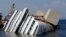 The capsized cruise liner Costa Concordia lies surrounded by cranes outside Giglio harbor, Italy, July 17, 2013. 