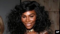 FILE - Serena Williams poses for a picture before the Serena Williams Signature Statement Spring 2017 collection is modeled during Fashion Week in New York.