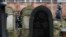 FILE - People visit the Warsaw Jewish Cemetery on Okopowa Street in Warsaw, Poland, Dec. 22, 2017.