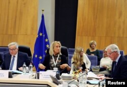 European Union's chief Brexit negotiator Michel Barnier (R) and European Commission President Jean-Claude Juncker (L) react at the start of the EU Commission's weekly college meeting in Brussels, Belgium, Nov. 21, 2018.