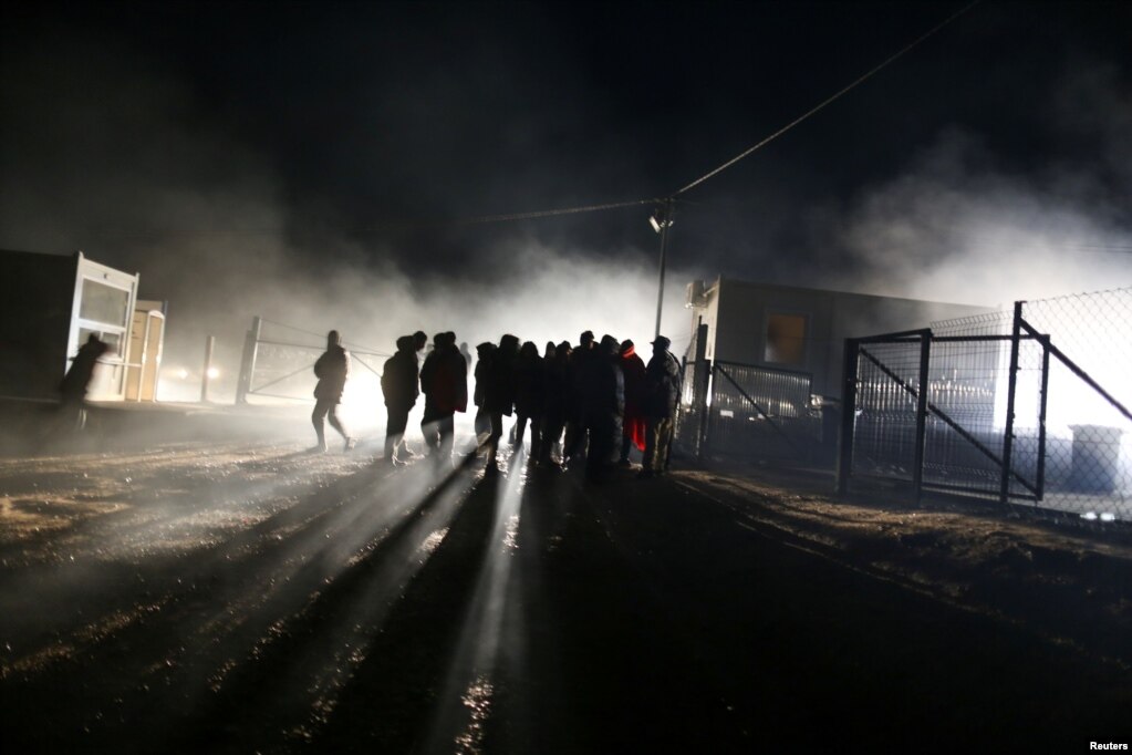 People stand at camp "Lipa" after it was closed, in Bihac, Bosnia and Herzegovina December 30, 2020. REUTERS/Dado Ruvic