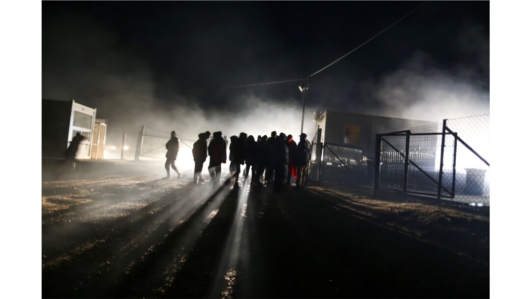 People stand at camp "Lipa" after it was closed, in Bihac, Bosnia and Herzegovina December 30, 2020. REUTERS/Dado Ruvic