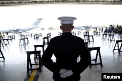 A U.S. Marine stands at attention as caskets containing the remains of American servicemen from the Korean War handed over by North Korea arrive at Joint Base Pearl Harbor-Hickam in Honolulu, Hawaii, U.S., Aug. 1, 2018.