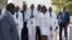 Accompanied by First Lady Martine Moïse, center right, and and acting prime minister Jean Michel Lapin, center left, President Jovenel Moise, center, arrives to lay flowers to mark the anniversary of the death of Haitian revolution leader.