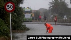 Emergency personnel work on a flooded road in Nelson, after the downgraded tropical cyclone Fehi brought heavy rain in New Zealand, Feb. 1, 2018.