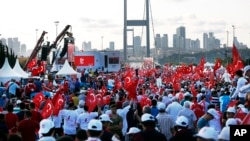 People gather at the July 15 Martyr's Bridge for a "National Unity March" to commemorate the one-year anniversary of the July 15, 2016 botched coup attempt, in Istanbul, Turkey, July 15, 2017. 