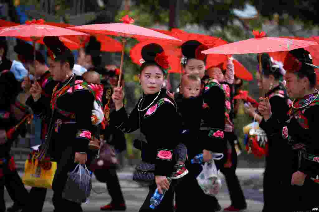 Women of the Miao ethnic minority in traditional costumes parade to celebrate the Miao new year festival in Leishan county, in China's southwestern Guizhou province, November 18, 2020.