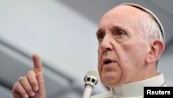 Pope Francis talks with journalists as he flies back Rome following his visit to Brazil July 29, 2013. Pope Francis, in some of the most conciliatory words from any pontiff on gays, said they should not be judged or marginalised and should be integrated i