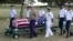 FILE - In this July 27, 2015 file photo, military pallbearers escort the exhumed remains of unidentified crew members of the USS Oklahoma killed in the 1941 bombing of Pearl Harbor that were disinterred from a gravesite at the National Memorial Cemetery of the Pacific in Honolulu.