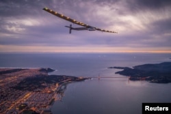 FILE - "Solar Impulse 2," a solar-powered plane piloted by Bertrand Piccard of Switzerland, flies over the Golden Gate bridge in San Francisco, California, U.S. April 23, 2016, before landing on Moffett Airfield following a 62-hour flight from Hawaii.