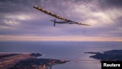 FILE - "Solar Impulse 2," a solar-powered plane piloted by Bertrand Piccard of Switzerland, flies over the Golden Gate bridge in San Francisco, California, U.S. April 23, 2016, before landing on Moffett Airfield following a 62-hour flight from Hawaii. 