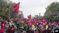 Supporters gather to welcome Nepal's former King Gyanendra Shah upon his arrival at Tribhuvan International Airport in Kathmandu, Nepal, March 9, 2025.