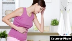 Pregnant woman with strong pain of stomach and nausea.