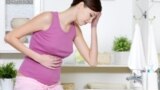 Pregnant woman with strong pain of stomach and nausea.