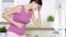 Pregnant woman with strong pain of stomach and nausea.