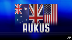 AUKUS tertulis di atas ilustrasi bendera Australia, Britania Raya dan AS. (Foto: AP)