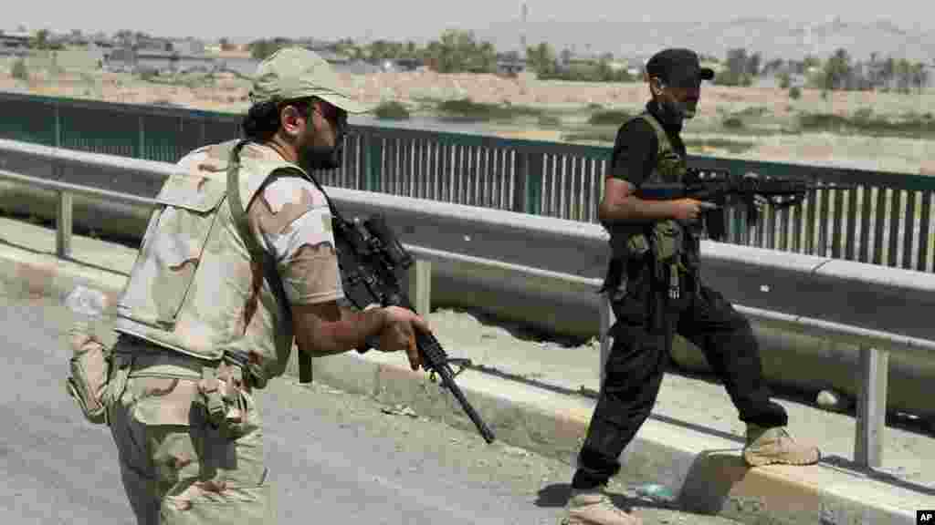 Iraqi security forces and Shiite militiamen patrol in Amirli, about 170 kilometers (105 miles) north of Baghdad, Iraq, Aug. 31, 2014. 