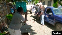 FILE - Workers load a truck with aid before heading to earthquake and tsunami affected areas in Honiara, Solomon Islands.