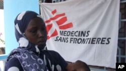 A Somali mother brings her child for vaccination for measles at a Medecines Sans Frontieres, Holland clinic hospital in Mogadishu, Somalia (File Photo).