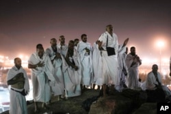 FILE - Muslim pilgrims pray on the rocky hill known as the Mountain of Mercy, on the Plain of Arafat, during the annual Hajj pilgrimage, near the holy city of Mecca, Saudi Arabia, on June 27, 2023. (AP Photo/Amr Nabil, File)