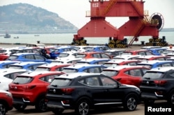 Sports utility vehicles (SUVs) waiting to be exported are seen at a port in Lianyungang, Jiangsu province, China, Apr. 5, 2018.